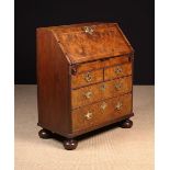 An 18th Century Figured Walnut Veneered Bureau inlaid with feather banding edged with stringing.