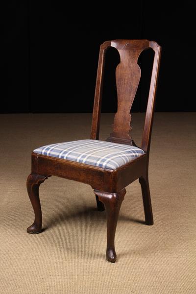 An Oak Queen Anne Side Chair having a vase shaped back splat and padded drop in seat now covered in