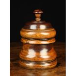 A 19th Century Turned Lignum Vitae Jar with moulded top surmounted by a mushroom capped urn finial,