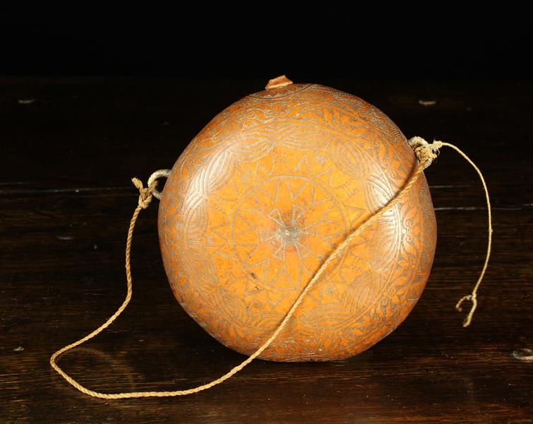 A Gourd Pilgrim Flask of round cushion form engraved with intricate decoration and having a small