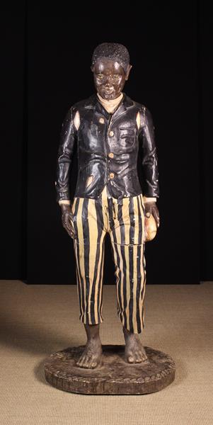 A Near Life Sized Late 19th Century Carved & Polychromed Advertising Figure of a bare-foot boy