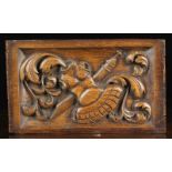 An Oak Dutch Panel with relief carved rebate depicting amour & sword; the instruments of war,