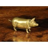 A Small Brass 'Go to Bed' Vesta Case in the form of a pig, 2" (5 cm) in length.