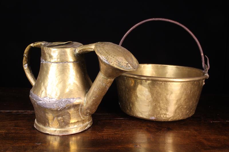 A Large Antique Sheet Brass Cauldron with lathe turned sides, a rolled rim,