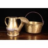 A Large Antique Sheet Brass Cauldron with lathe turned sides, a rolled rim,