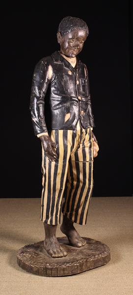 A Near Life Sized Late 19th Century Carved & Polychromed Advertising Figure of a bare-foot boy - Image 2 of 3