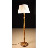 A Walnut Standard Lamp.