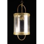 A Hall Lantern. The cylindrical glass shade with pierced brass mounted and a foliate bulb holder.