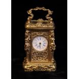 A Vintage Miniature Carriage Clock set in a gilt metal case intricately cast in the Louis XVI style
