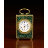 A Miniature Clock in a gilt metal case clad with faux shagreen.