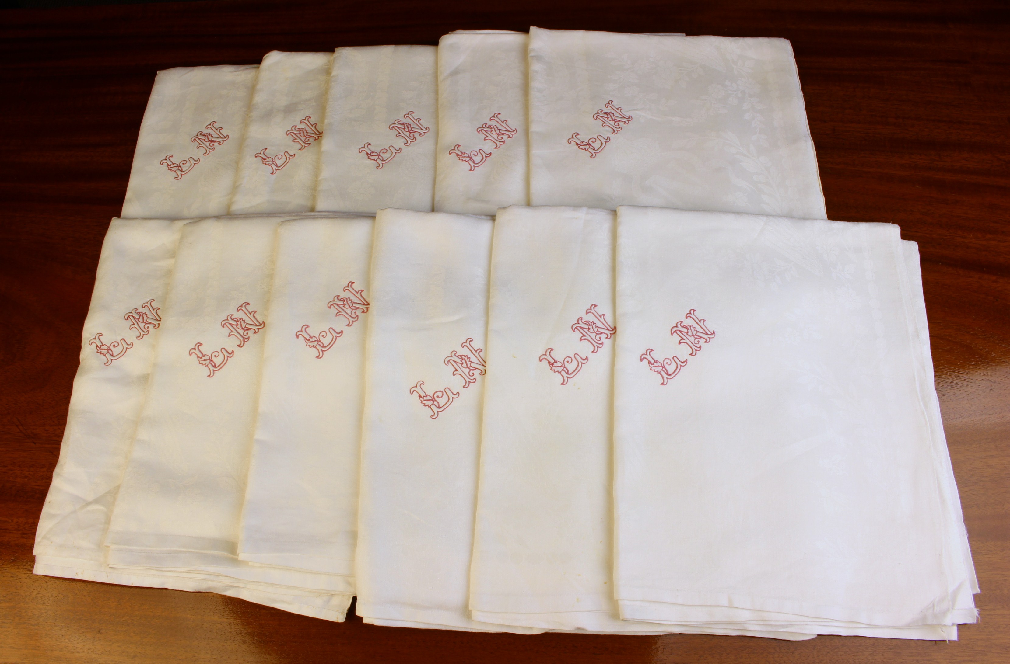 A Set of Eleven Large White Damask Table Napkins reputed to have come from the Royal Apartments of