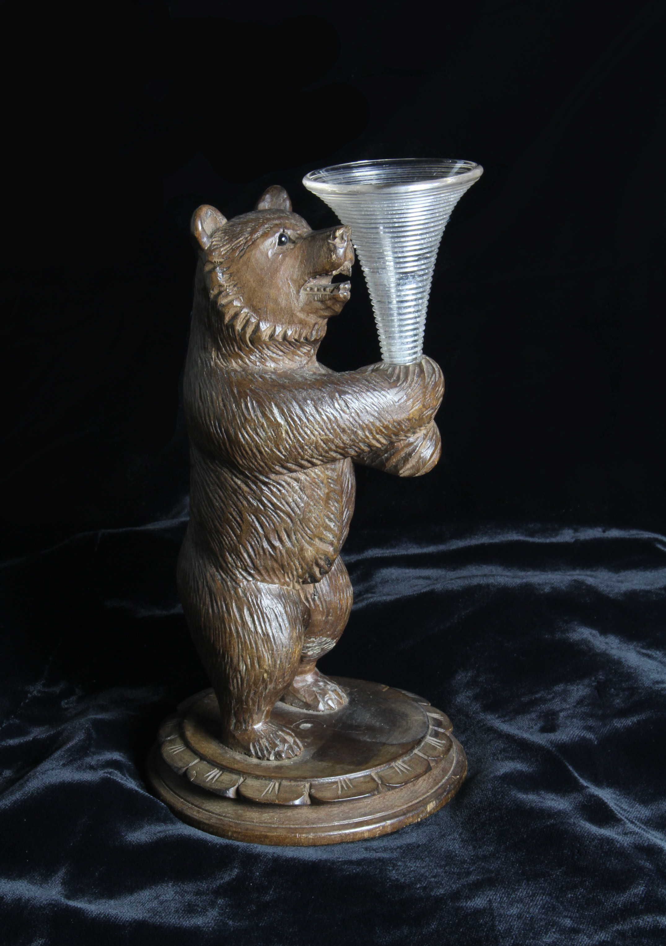 A Small 19th Century Carved Wooden Black Forest Bear with inset glass eyes,