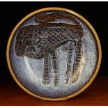A Large Stoneware Art Pottery Charger emblazoned with a lion on a blue speckled glazed ground,