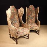 A Pair of Arts & Crafts High Backed Wing Armchairs.