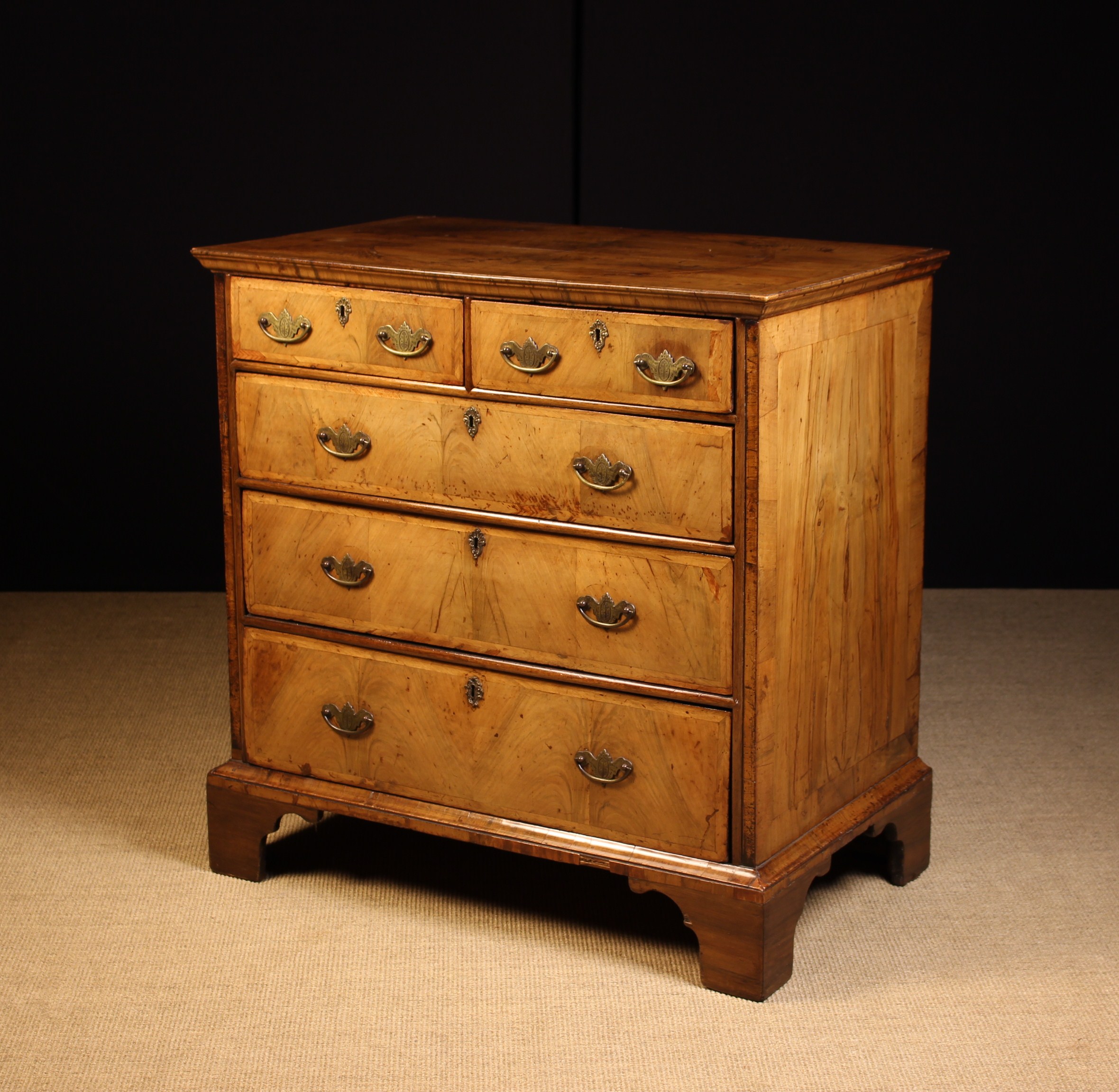 An Early 18th Century Oak Chest of Drawers with later walnut veneers.