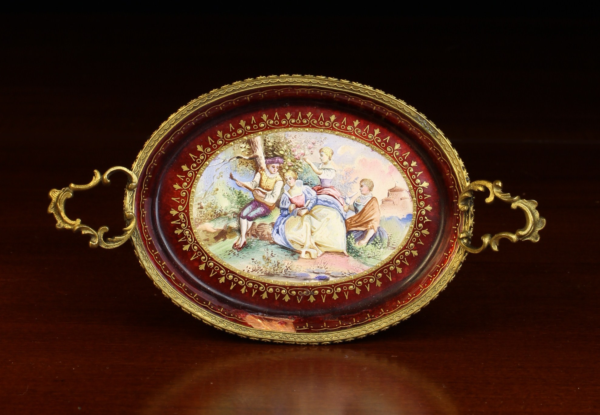 A Miniature Viennese Enamel Oval Tray with gilt bronze mounts (A/F).