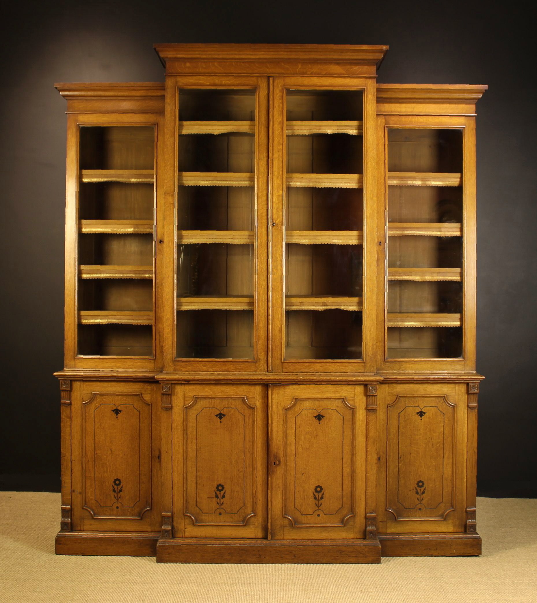 A Handsome Late Victorian Arts & Crafts Oak Break-front Library Bookcase stamped 'Garrett & Sons'