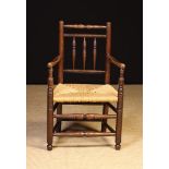 A 19th Century Child's Rush-seat Spindle-back Armchair.