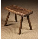 A 19th Century Primitive Elm Stool.