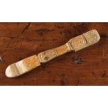 An Antique Naively Carved Treen Knitting Sheath emblazoned with a skull and diagonal crosses,