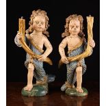 A Pair of 17th Century Carved & Polychromed Wooden Figural Candle-holders.