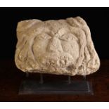 A Primitive Carved Stone Fragment Head mounted on a metal display stand, 8" (20 cm) high,