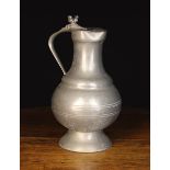 A Large 19th Century Pewter Baluster Flagon having a flat hinged lid stamped with a fleur-de-lis