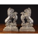 A Pair of Victorian Cast Iron Fire Ornaments/Door Stops cast in the form of heraldic lions sejant