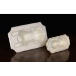 Two 19th Century Cream-ware Culinary Moulds: Both forming recumbent lions on rectangular bases with
