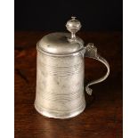 An 18th Century Pewter Pint Tankard with hinged lid.