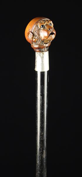 An Edwardian Silver-banded Ebonised Walking Stick with articulated Monkey's head handle.