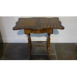 A Victorian rosewood foldover top games worktable with games board top over a fitted drawer on