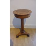 A Victorian mahogany statue stand with a revolving top on a octagonal column and tripartite platform