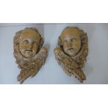 A pair of carved wood cherub carvings, 29cm tall x 22cm wide, crack to one side of face otherwise