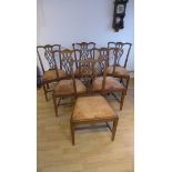 A set of six Georgian style mahogany dining chairs with entwined vase shaped splats with leather
