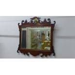 A Georgian style mahogany phoenix mounted mirror, 57cm tall x 58cm wide, with restorations