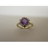 A 9ct hallmarked yellow gold amethyst and tanzanite cluster ring, size R, head approx 12mm x 12mm,