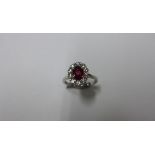 A hallmarked 950 platinum, diamond and ruby ring, size M, head approx 9mm x 11mm, 5.7 grams, in good