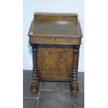 A 19th century walnut Davenport with a single door enclosing four drawers, in need of some