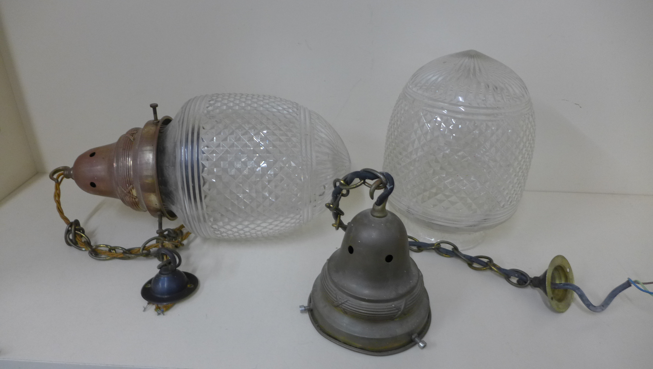 A pair of cut glass hanging ceiling lights with brass holders, 38cm long x 20cm wide, both shades