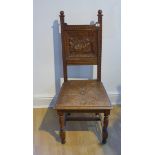 A Victorian carved oak side chair with a carved back of musicians in a tavern, 108cm tall x 48cm