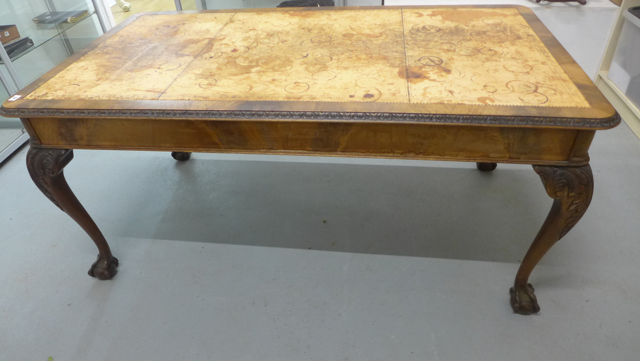 A mahogany library table with a leather inset top on carved cabriole legs, 77cm tall x 166cm x 91cm,