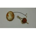 A gold plated folding pocket watch key Itaglio set fob, 5cm long, and a rolled gold mounted cameo,