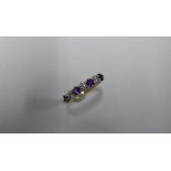 A hallmarked 18ct yellow gold diamond and amethyst seven stone ring, size P/Q, approx 2.4 grams,