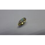 A hallmarked 18ct yellow gold opal three stone ring, size Q, approx 4.0 grams, some wear and chips