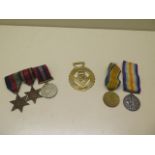 Two WWI medals to T-4449 Pte SW Holloway The Queens R, three unnamed WWII medals and a Churchill