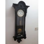 An ebonised single weight Vienna wall clock - Height 114cm - in generally good condition, running