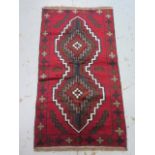 A hand knotted woollen Baluchi rug - 140cm x 77cm