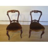 A nice pair of 19th century rosewood side chairs with upholstered seats on cabriole legs