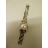 A 9ct yellow gold manual wind wristwatch on a gold plated strap - case is 25mm wide - total approx